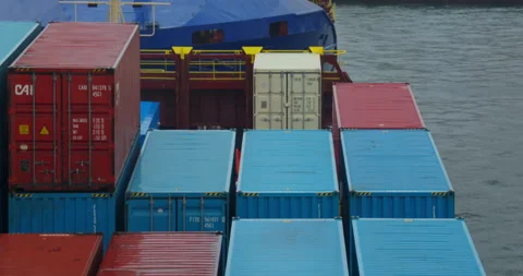Containers stacked across ship deck form colorful grid Видео 320774081