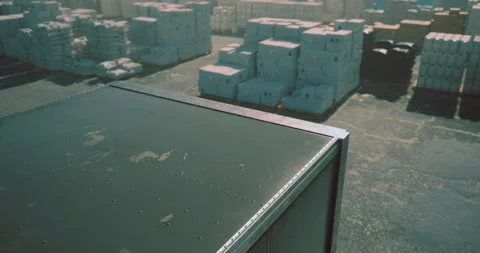 Containers stacked in a busy shipping yard during bright daytime hours Stock Footage 329176900