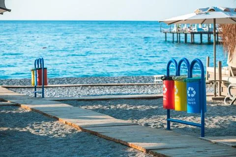 Containers, trash bins for separate waste on the beach, waste recycling, envi Stock Photos