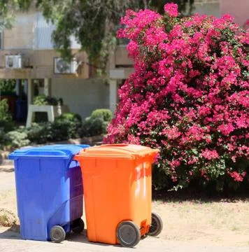 Containers for waste from multi-colored material on a sunny day against the b Stock Photos