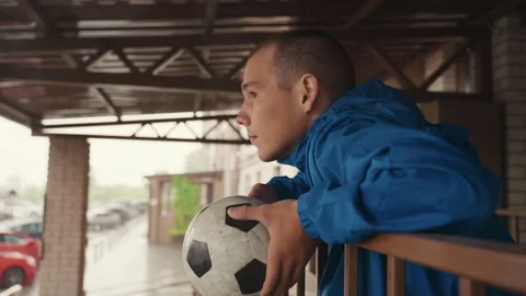 Contemplating changed game schedule in gloomy weather, Individuals and Stock Footage 329559831