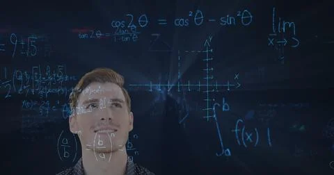 Contemplating mathematical equations and graphs, man focusing on problem-solving Stockfoto's