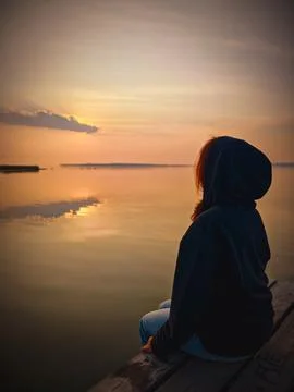 Contemplating sunset by the lake Stock Photos