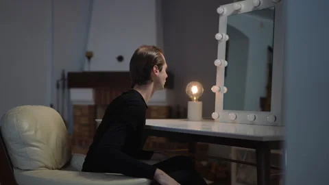 Contemplation at the Vanity Mirror A Creative Moment to Reflect Upon and Enjoy Stock Footage 316040374