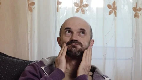 Contemplative Bearded Middle-Aged Man Looking Up with Thoughtful Expression Stock Footage 339318829