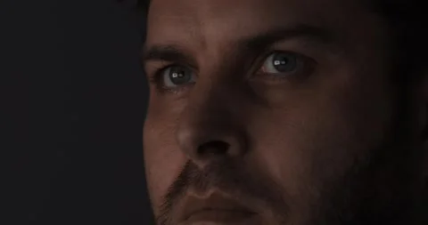 A contemplative closeup image capturing a mans intense and expressive eyes full Stock Footage 297694236