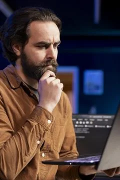 Contemplative developer feeling worried about potential cyberattacks, close up Stock Photos