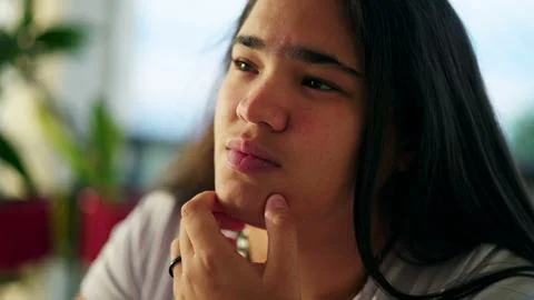 Contemplative Expression of an Ethnically Diverse Asian Young Woman in her .. Stock Photos
