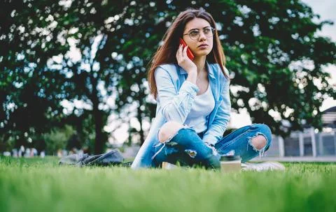 Contemplative female calling to operator for conversation consultancy during Stock Photos
