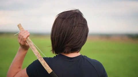 Contemplative figure with staff persists, Isolated figure holds staff under Stock Footage 327613247