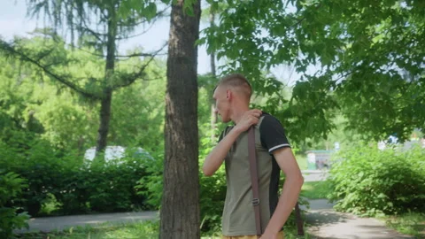 Contemplative Individual Beneath Leafy Branches, Solitary Man Appears Video stock 324611477