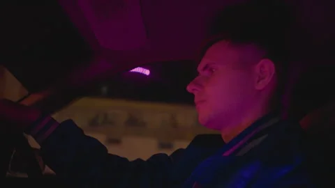 Contemplative man navigating through neon glow quiet streets, Private Stock Footage 324956828