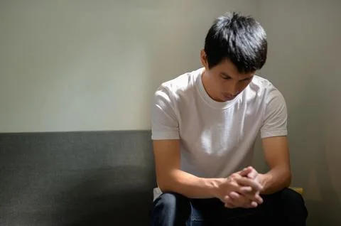 Contemplative Man Sitting Alone with Pensive Expression in Room Stock Photos