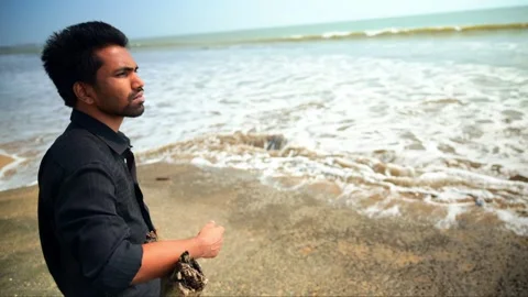 Contemplative Man Standing on the Beach Stock Footage 281319230