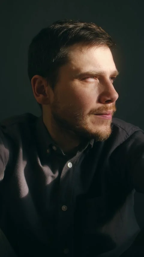 Contemplative man turning and looking into the camera Video stock 337550875
