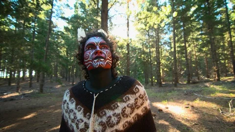 Contemplative mystical painted man in surreal setting looking up at forest HD 25 Stock Footage 87248039