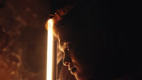 Contemplative Portrait with Dramatic Lighting Stock Footage 296680649
