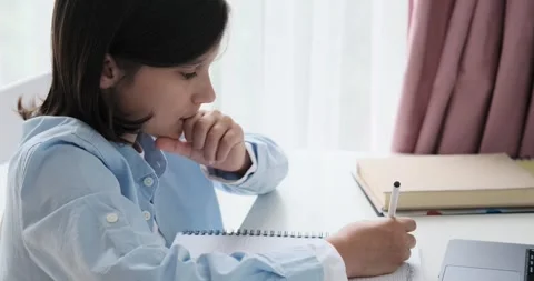 Contemplative Schoolboy Doing Homework at the Table Stock Footage 250273984