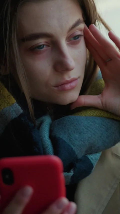 A contemplative young woman is using her smartphone in the beautiful natural Stock Footage 314168705