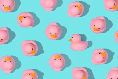 Contemporary art style pattern of small rubber duckies in a vibrant summery colo Stock Photos
