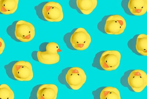Contemporary art style pattern of small rubber duckies in a vibrant summery colo Stock Photos