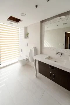 Contemporary bathroom interior decoration with a rectangular mirror, brown .. Stock Photos