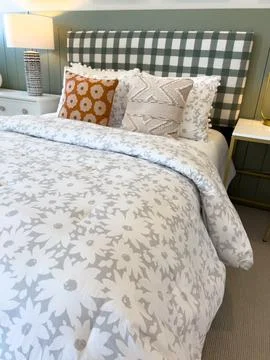 Contemporary Bed with Gingham Patterned Headboard Stock Photos