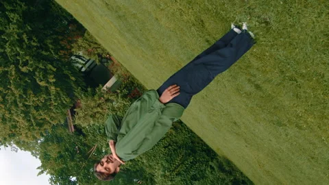 Contemporary Boy Performs Improvised Dance Elements On Sunny Lawn 4k Video Stock Footage 275292048