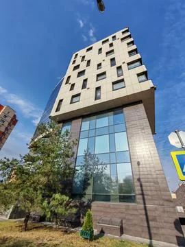 Contemporary building with sharp angles, glass windows, and light paneling Stock Photos