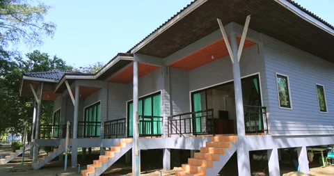Contemporary bungalow homes, featuring elevated staircases and Stock Footage 303815268
