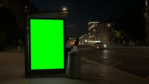 Contemporary bus stop equipped with luminous green banners 스톡 동영상 110428226