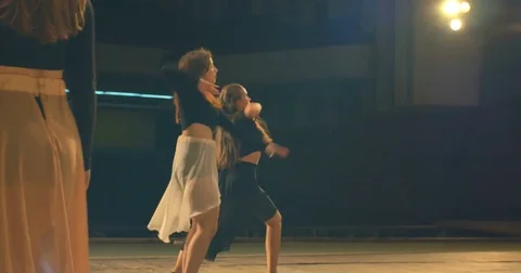 Contemporary dance performance of dancers on the stage. Back view. 库存影片 79619508