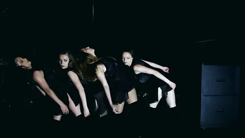 Contemporary dance performance of four dancers on dark Stock Footage 69223989