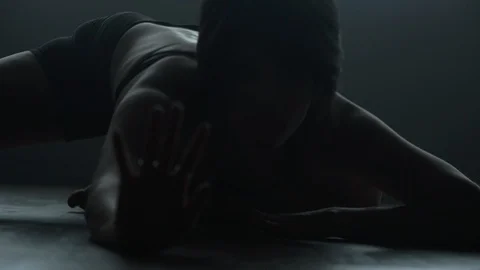Contemporary dancer dancing on floor reaching out towards camera Vídeo Stock 104268814