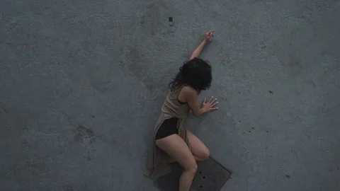 Contemporary dancer falling on concrete floor in industrial warehouse 스톡 동영상 104418681