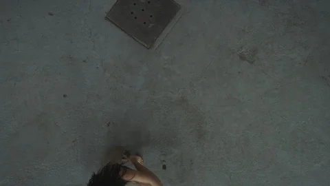 Contemporary dancer falling on concrete floor in industrial warehouse 스톡 동영상 104419742