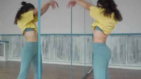 Contemporary dancer performs expressive movements in front of a mirror. Stock Footage 287099641