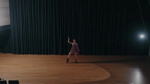 Contemporary dancer performs solo on stage in spotlight Stock Footage 309292785