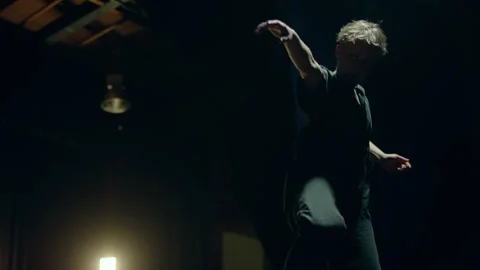 Contemporary Dancer practicing on the stage under the light Stock Footage 279810687