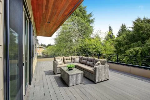 Contemporary deck features a modern wicker sectional accented with gray seat  Stock Photos