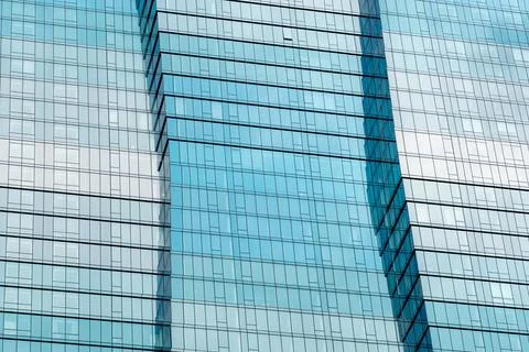 Contemporary glass architecture featuring a dramatic undulating facade Stock Photos