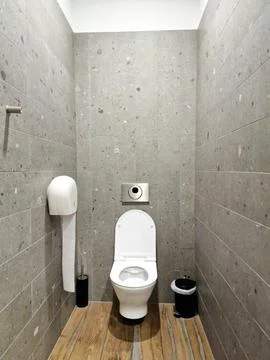 Contemporary interior of empty public restroom. Open toilet bowl, wc. Close u Stock Photos