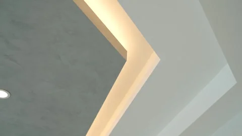 Contemporary interior featuring geometric ceiling design with deep recess Video stock 273832041