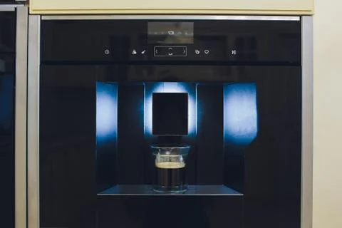 Contemporary kitchen with built in coffee machine. Stock Photos