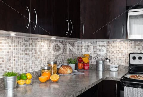 Contemporary kitchen with food ingredients on countertop Stock Photos