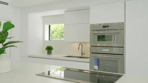 Contemporary kitchen interior with elegant design and white cabinetry, built-in Stock Footage 276027056