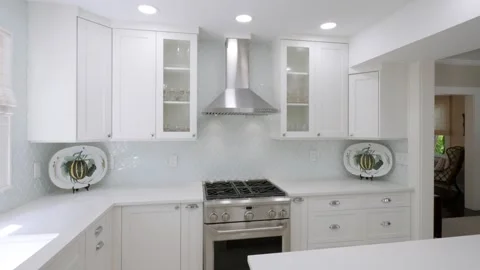 Contemporary kitchen interior with white cabinets. Stainless steel range and Stock Footage 275905684