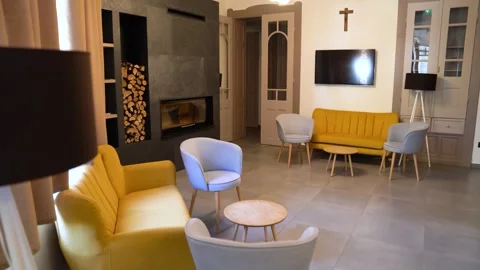 Contemporary living room with yellow sofas, gray armchairs, and and simple decor Stock Footage 329205153