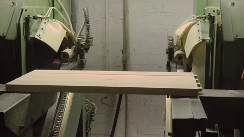 Contemporary machine tool used to process wooden boards and pile of planks in li Stock Footage 147078395