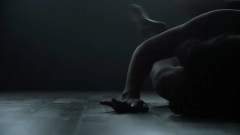 Contemporary modern dancer on floor dancing in dark moody dance studio 스톡 동영상 104268922